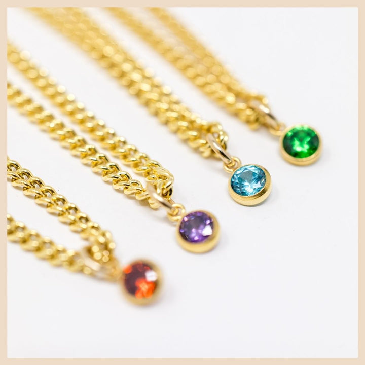 The Gold Curb Chain Birthstone Necklace

January - Garnet, February - Amethyst, March - Aquamarine, May - Emerald, 

Based in Lexington, Kentucky