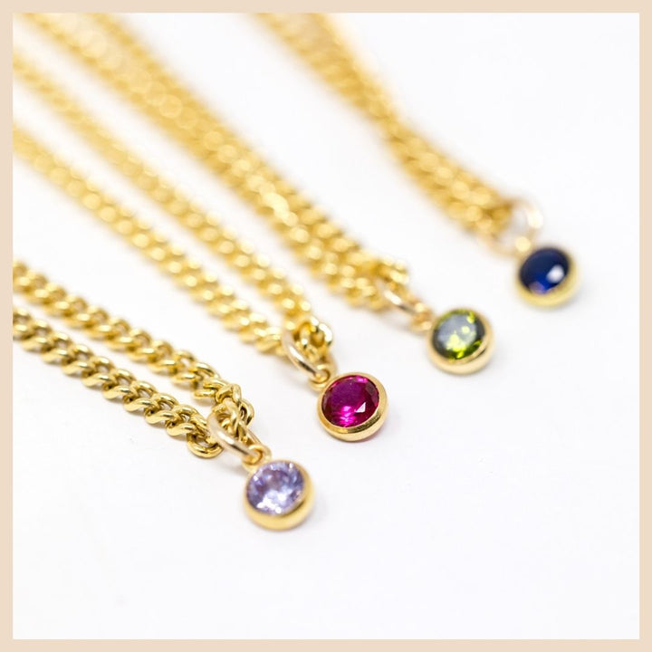 The Gold Curb Chain Birthstone Necklace 

 June - Light Purple Amethyst, July Red Ruby Corundum,  August - Peridot, September - Blue Sapphire

Based in Lexington, Kentucky